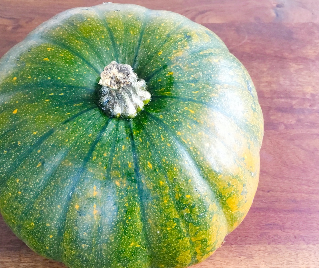 a green pumpkin on the table