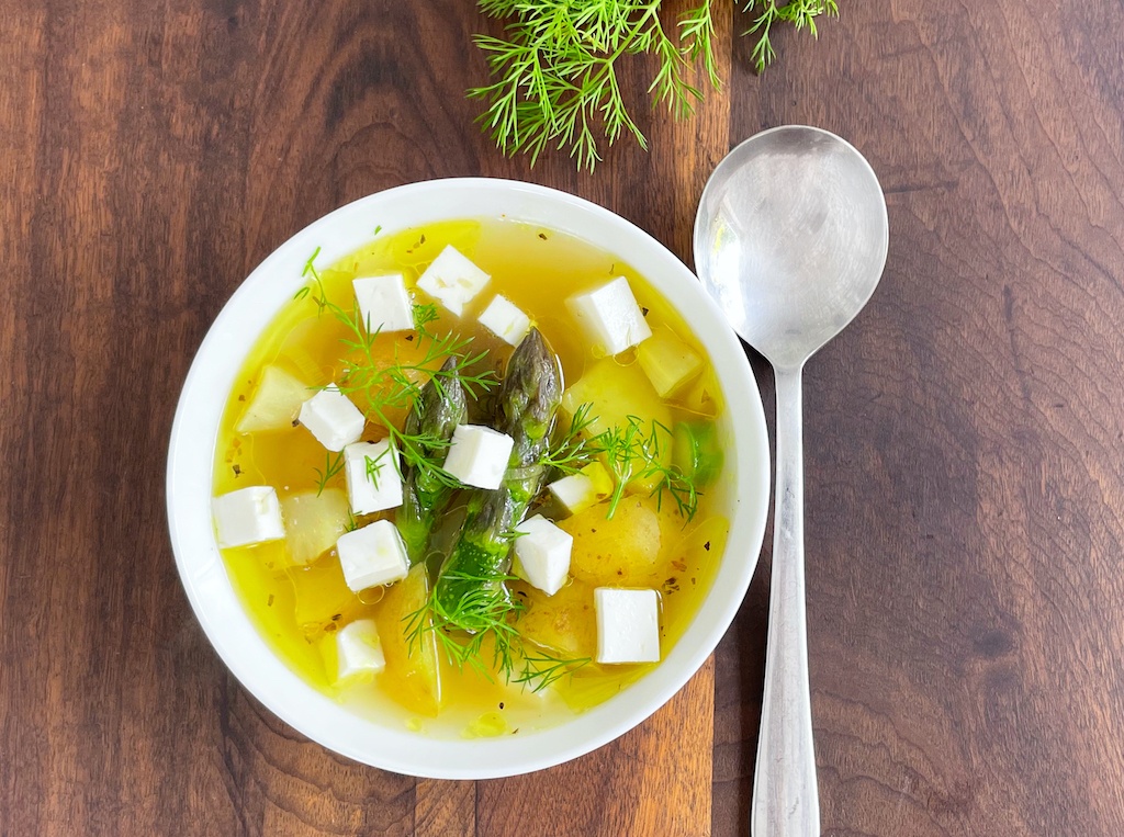 asparagus potato and feta soup flat lay with a spoon