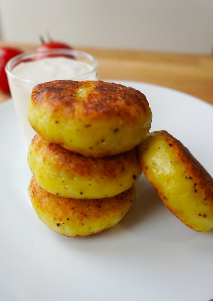 cheese stuffed potatoes in serving plate stacked up on each other