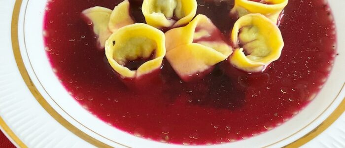 Christmas red borscht with dumplings in a plate a close up