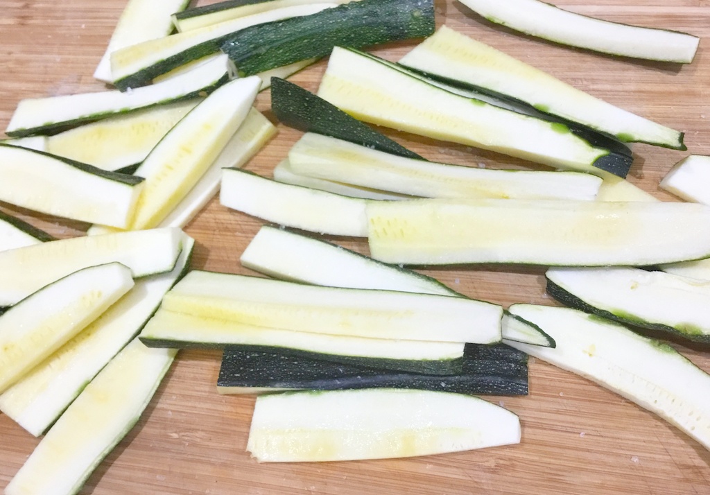 raw courgette fingers on the chopping board