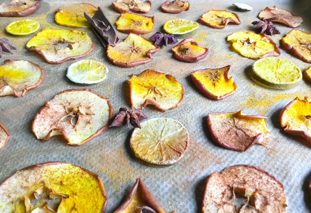 dried apples and limes on the baking parchment