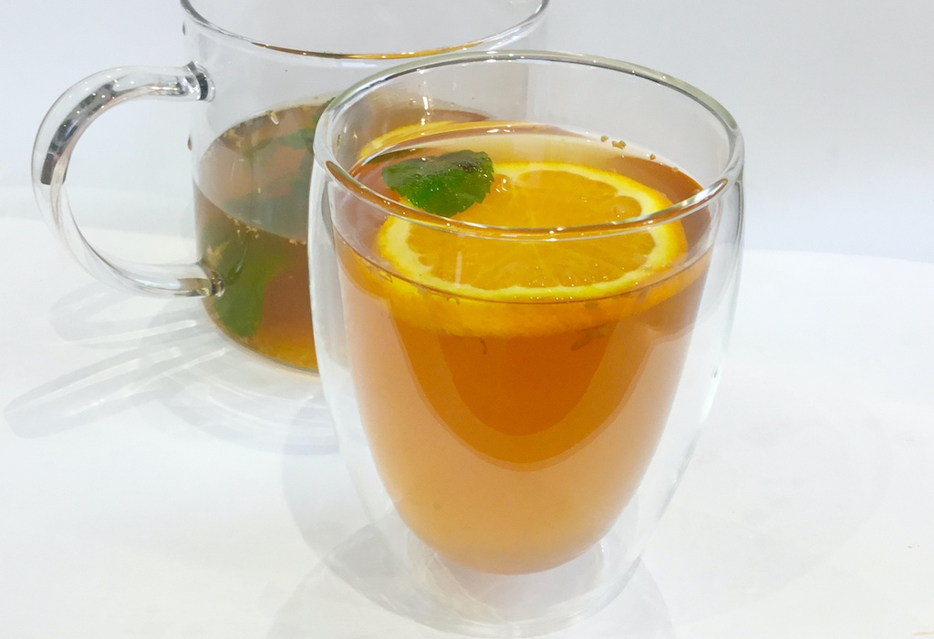 fresh orange and ginger tea in the glass
