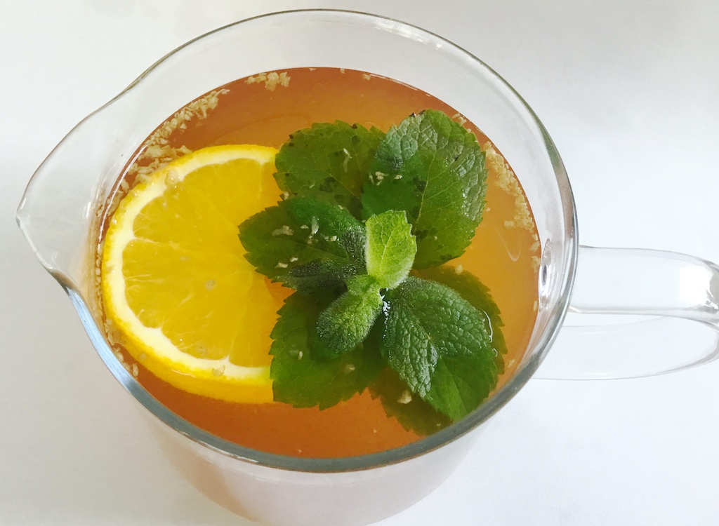 fresh orange and ginger tea in the teapot