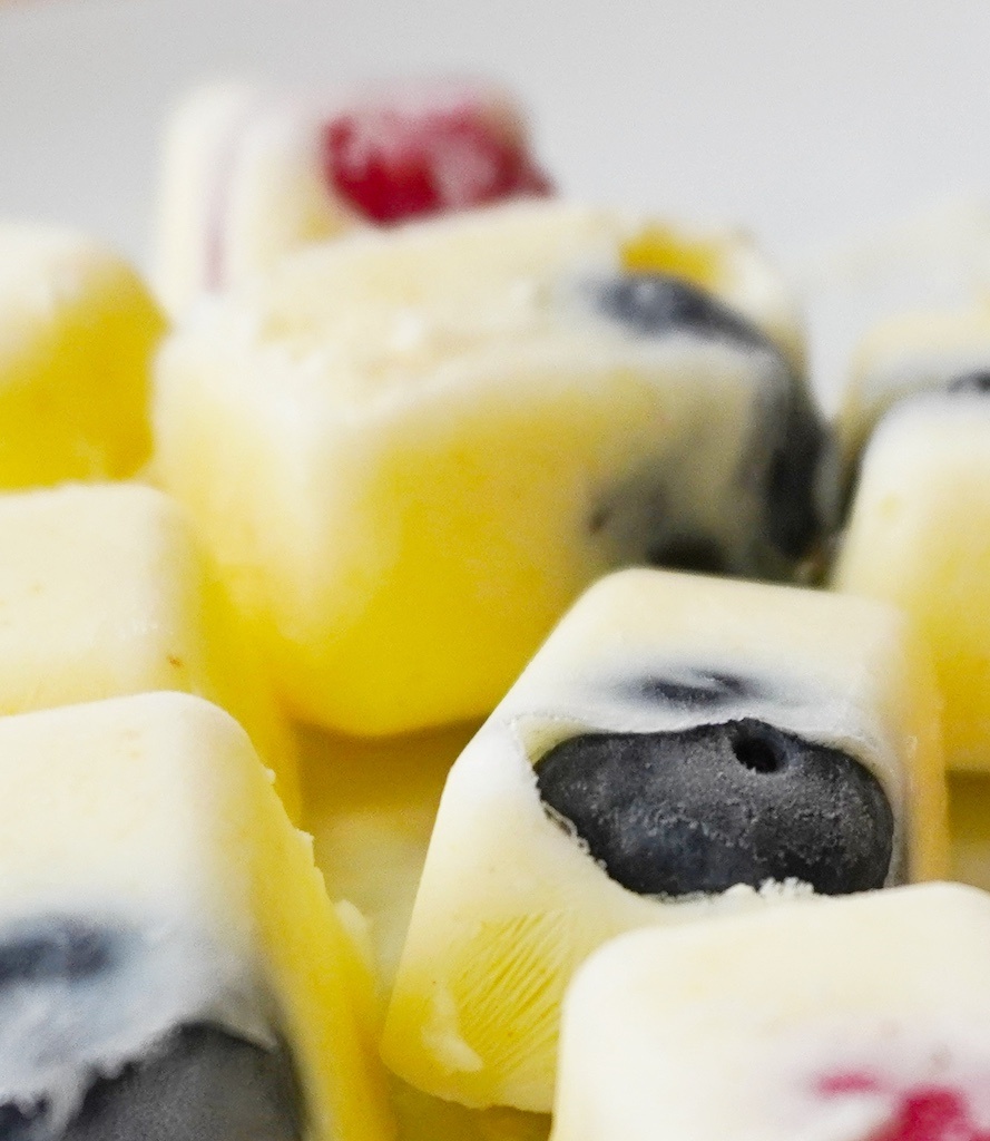 frozen yoghurt berry bites close up on frozen blueberry