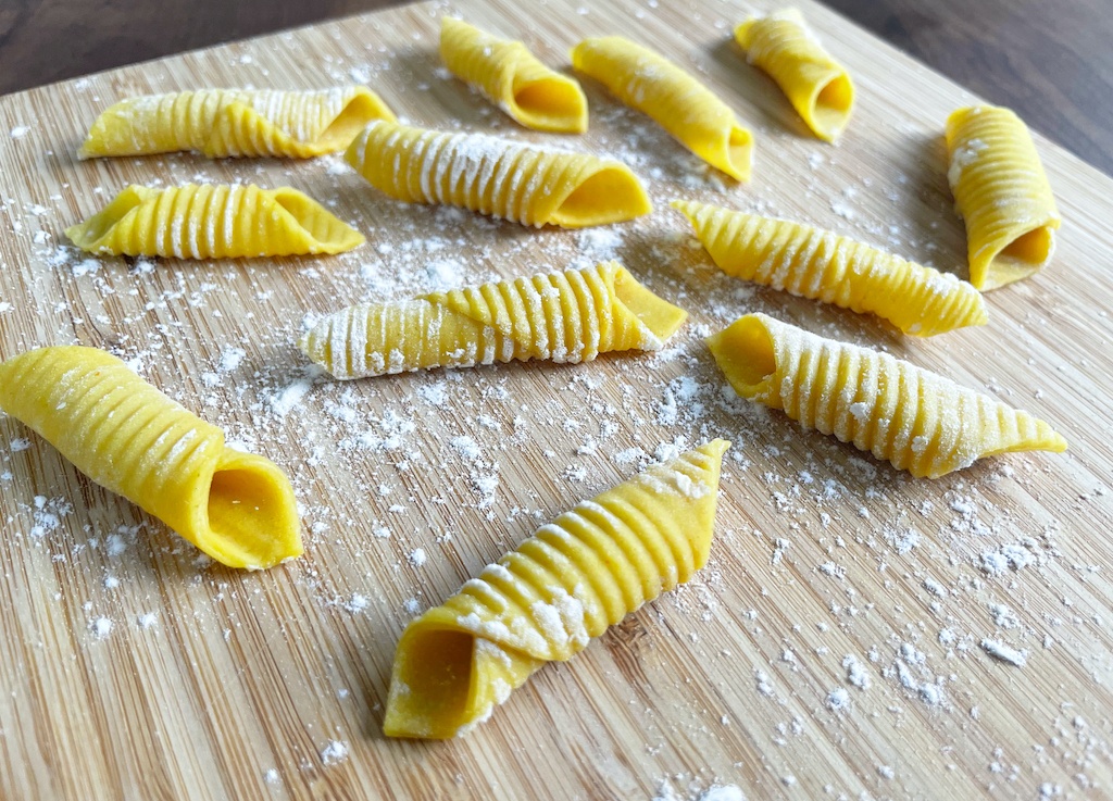garganelli pasta on wooden board - a detailed close up