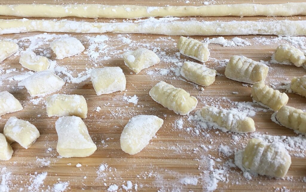 Italian gnocchi or Polish kopytka on the chopping board ready to cook