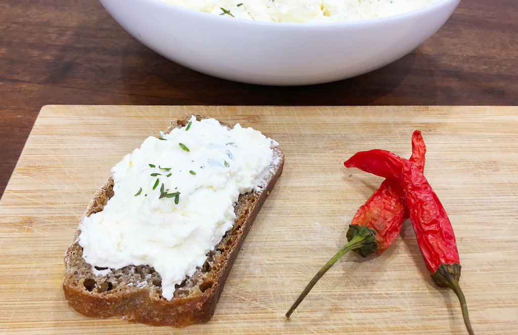 homemade herb ricotta cream on a slice of bread