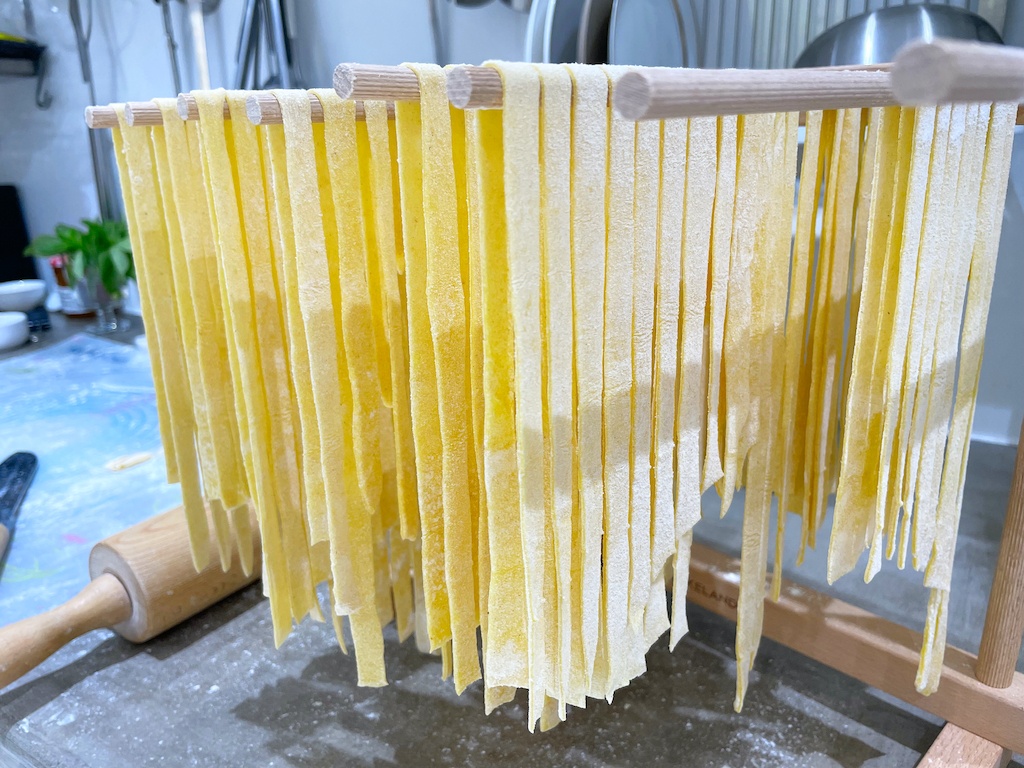 homemade pappardelle on a drying rack