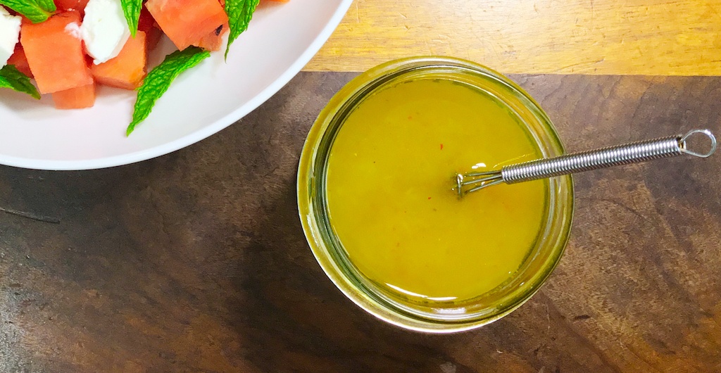 honey and lemon dressing in a glass cup