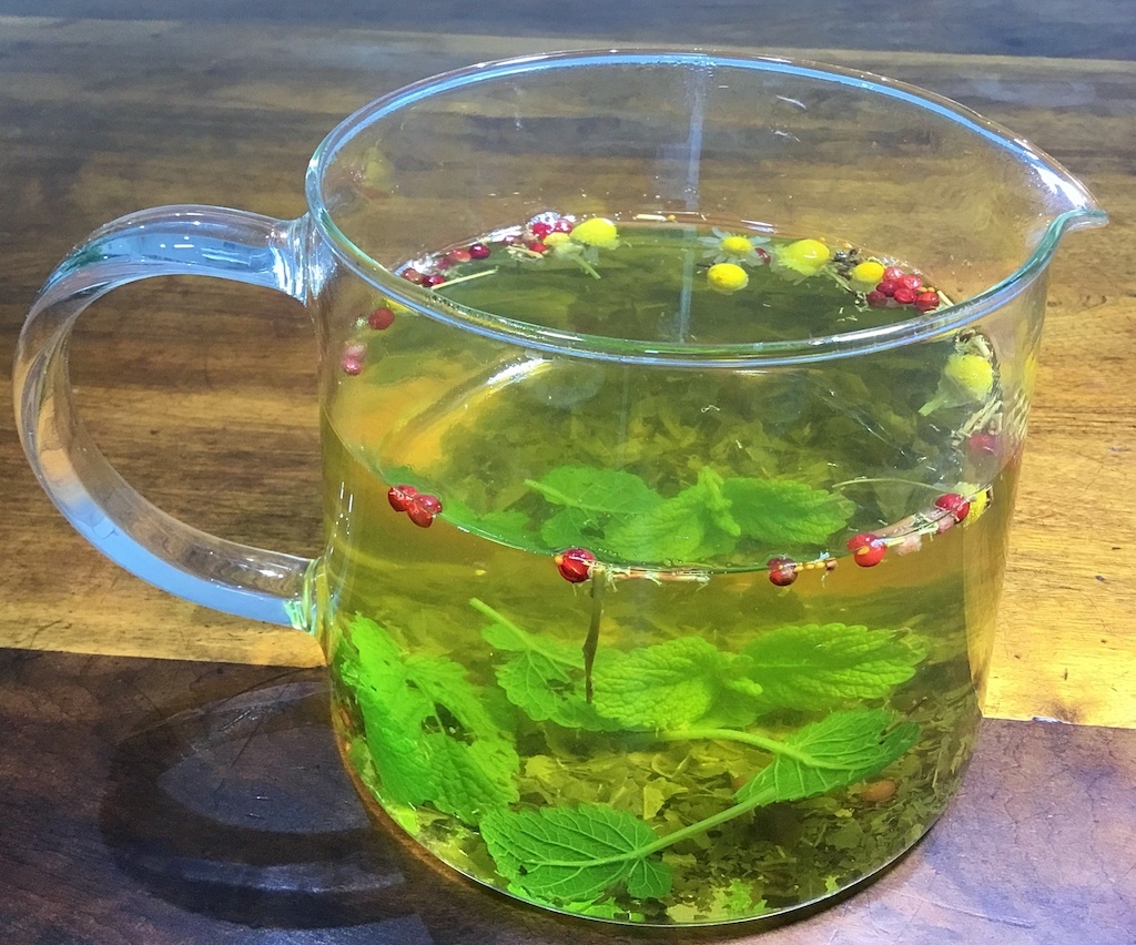 lemon balm green tea in a tea pot on the table