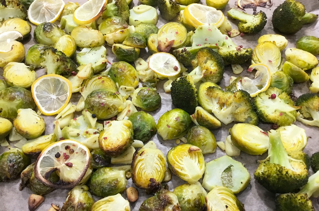 lemon-roasted Brussels sprouts and broccoli on the baking sheet