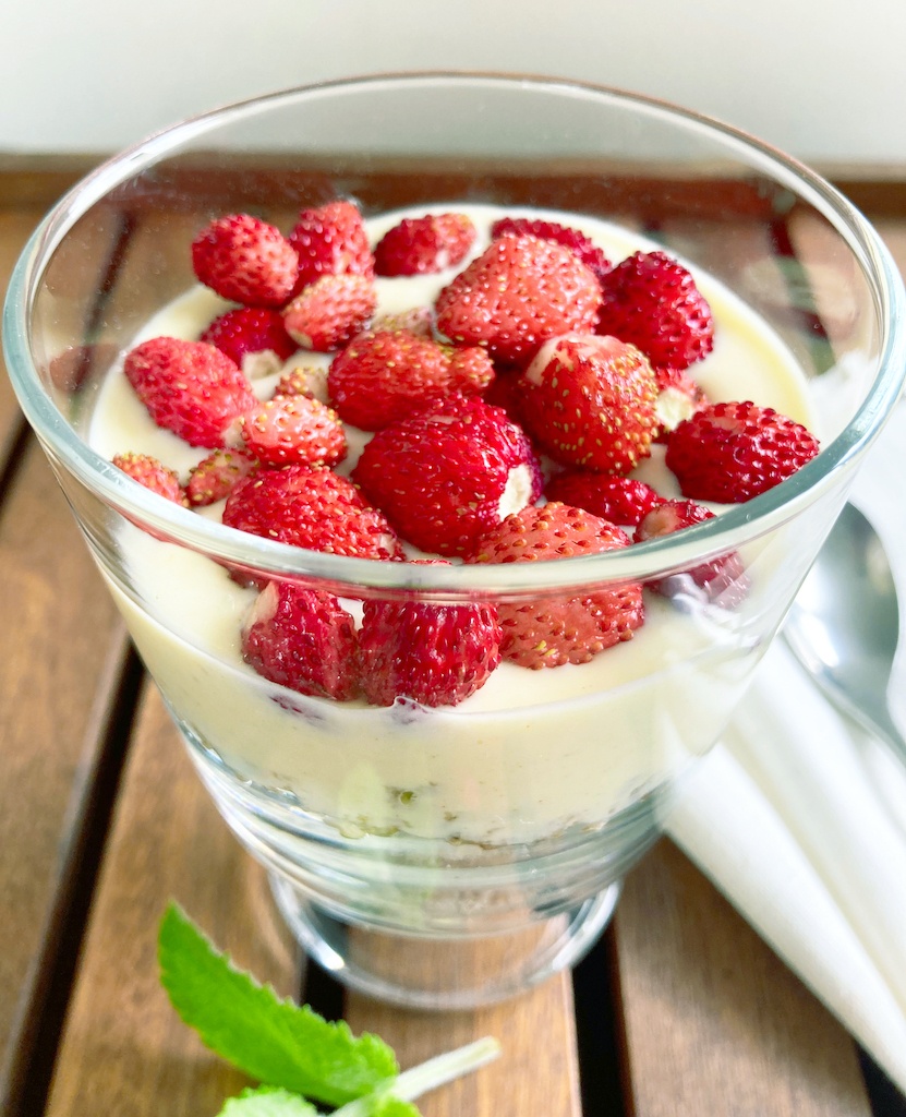 oats with spiced yoghurt and wild strawberries in a serving glass