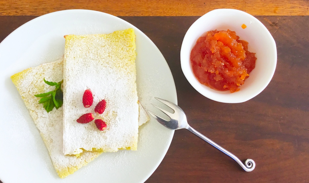 pannukakku - Finnish oven pancake on the plate with jam on the side