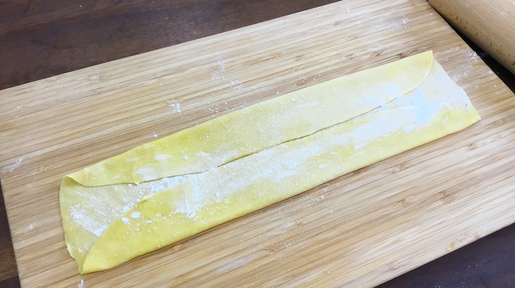 pasta sheet on the chopping board ready to cut