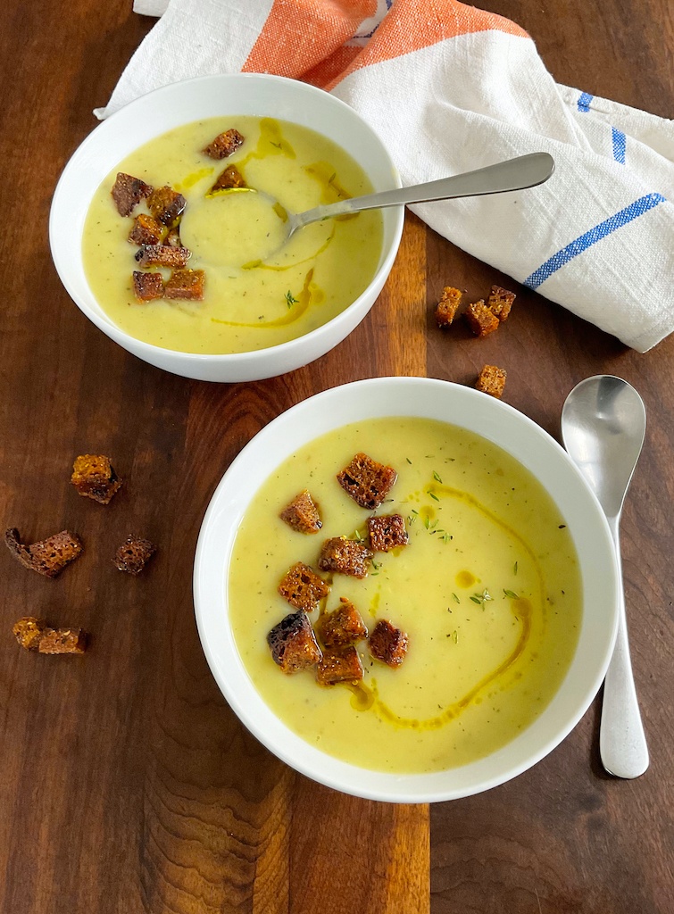 potage parmentier or leek and potato soup in two bowls flat lay