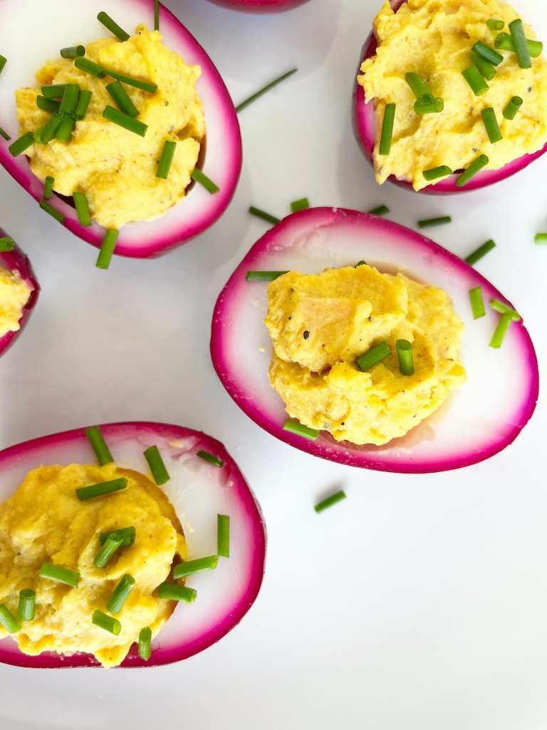 purple devilled eggs on the serving plate flat lay