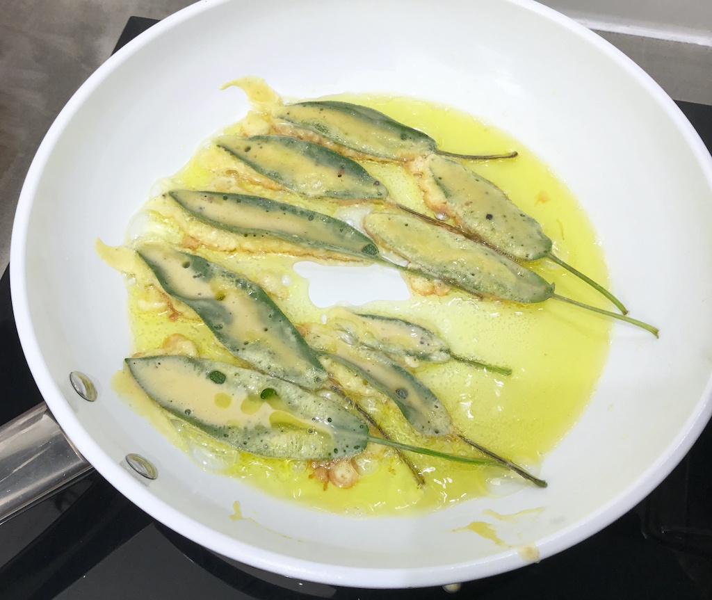 sage leaves in beer batter on the frying pan