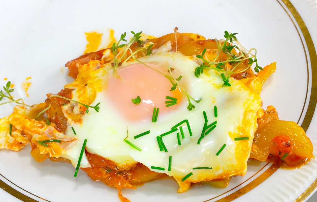 shakshouka - a close up on a piece on a serving plate