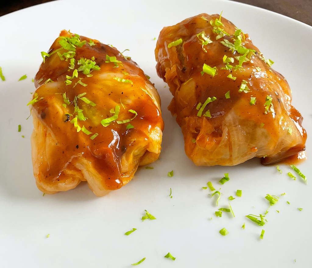 stuffed cabbage leaves or rolls on serving plate a close up
