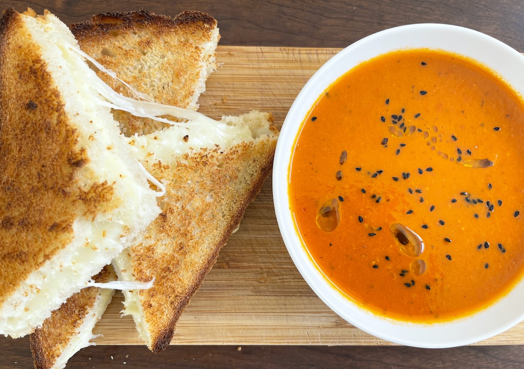 tomato harissa soup with cheesy toasts on the side
