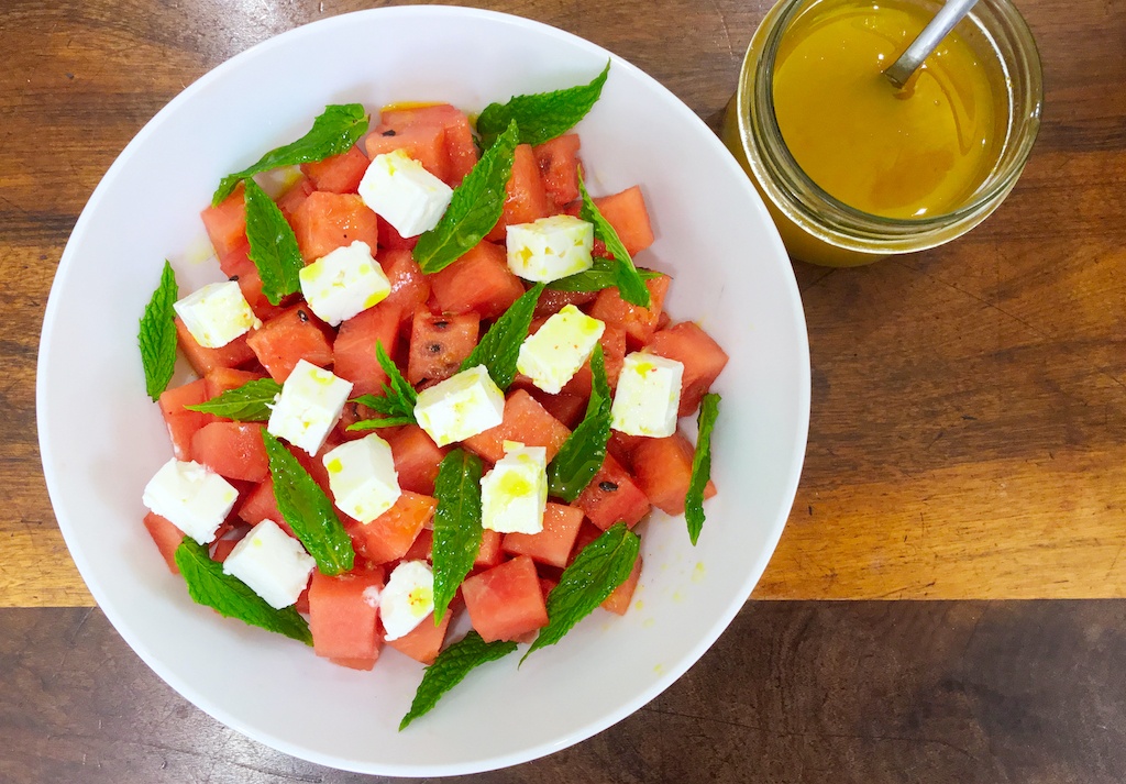 watermelon and feta salad with dressing in a jar form the top