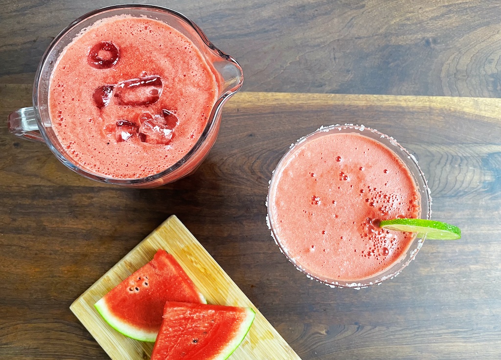 watermelon margarita in a jar and a glass flat lay